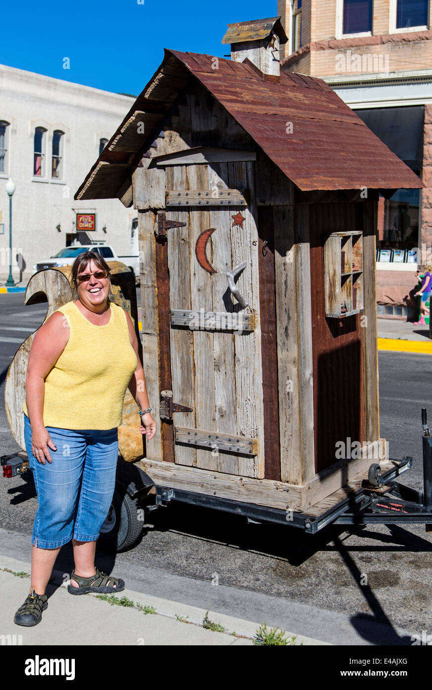 Out house on trailer; visitors enjoy artwork during the annual small town ArtWalk Festival Stock Photo