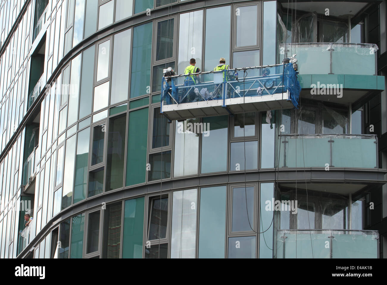 London, UK. 07th July, 2014. Window cleaners got on with their job on Stratford High Street before the Tour de France peloton rode past. Credit:  Credit:  david mbiyu/Alamy Live News Stock Photo