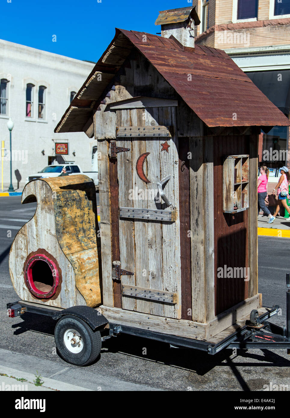 Out house on trailer; visitors enjoy artwork during the annual small town ArtWalk Festival Stock Photo