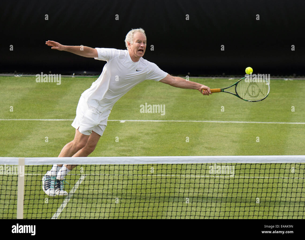 Stuttgart, Germany. 07th July, 2014. US tennis player John McEnroe in action against Stich from Germany during the first time a match of the Mercedes Cup Tennis was played on grass in Stuttgart, Germany, 07 July 2014. The ATP tpurnament will be played on grass instead of clay from 2015. Photo: DANIEL MAURER/DPA/Alamy Live News Stock Photo