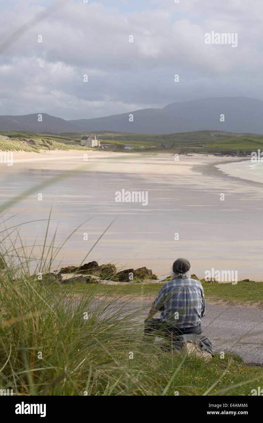 A man contemplates life beside the sea, in Durness, Northern Scotland Stock Photo