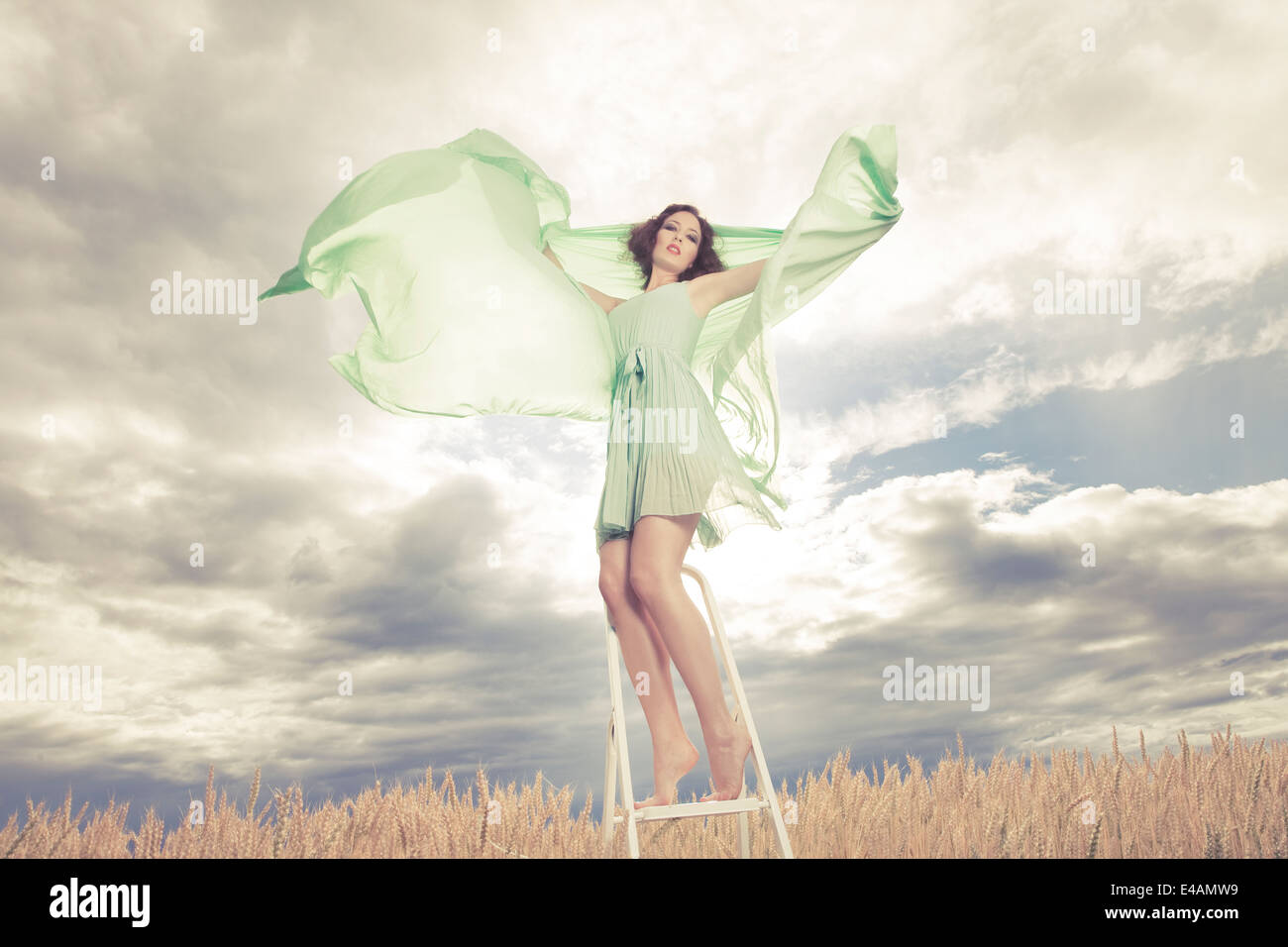 Beautiful woman in green dress background Stock Photo - Alamy