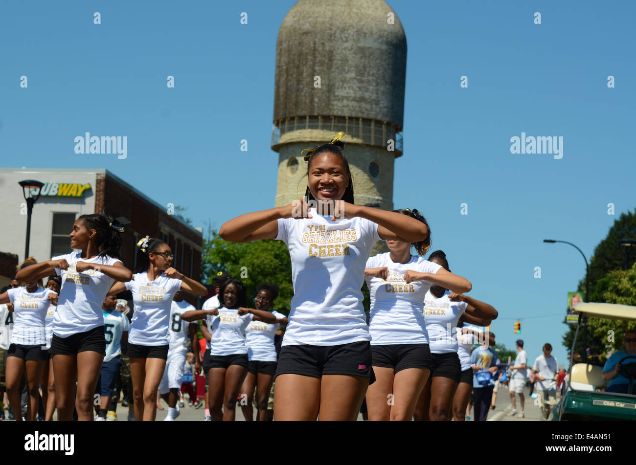YPSILANTI, MI - JULY 4: Ypsilanti high school cheer team members at the 4th of July parade on July 4, 2014 in Ypsilanti, MI. Stock Photo