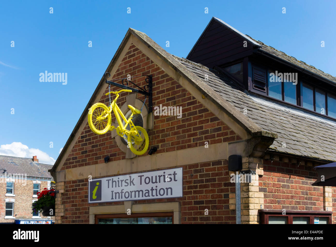 Tour de France in Yorkshire 2014 promotes sales, here a yellow bicycle on the Tourist Information Office Thirsk Stock Photo