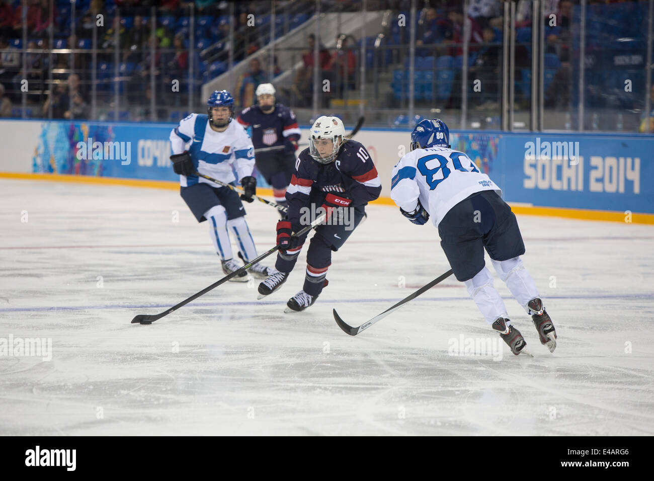 Meghan Duggan (USA) and Tea Villila (FIN) during ice hockey game at the Olympic Winter Games, Sochi 2014 Stock Photo
