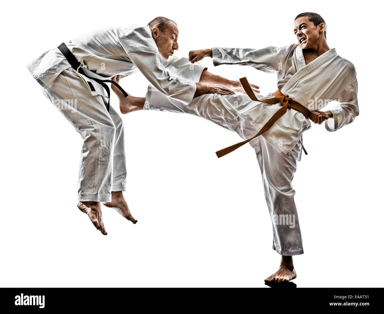 two karate men sensei and teenager student fighters fighting isolated on white background Stock Photo