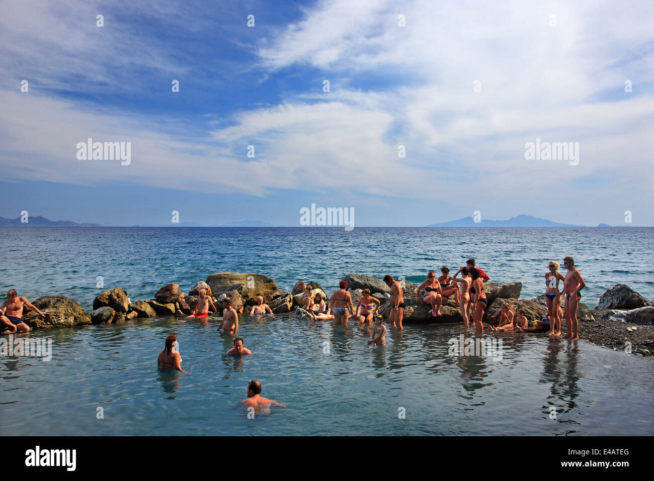 Enjoying a natural spa at the thermal springs of Therma (or 'Empros Thermes') beach, Kos island, Dodecanese, Greece. Stock Photo