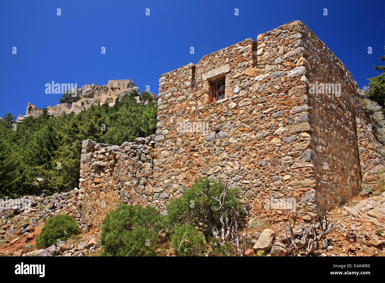 Old house at the abandoned village of Old Pyli. In the background the castle of Pyli, Kos island, Dodecanese, Greece. Stock Photo