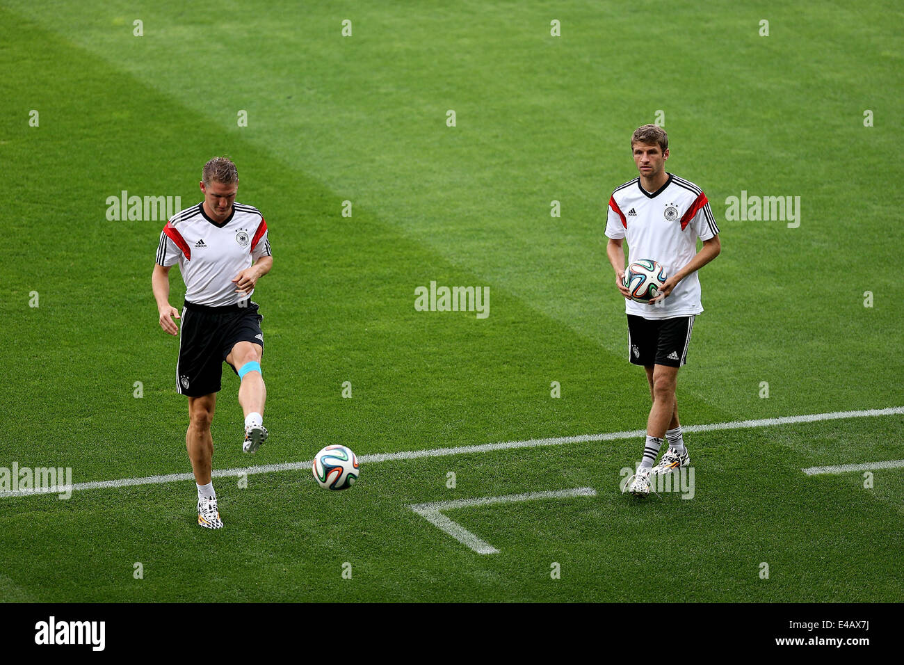 Belo Horizonte, Brazil. 7th July, 2014. Bastian Schweinsteiger (L) and Thomas Muller 0f Germany take part in a training session in Belo Horizonte, Brazil, on July 7, 2014. Germany will play Brazil in their 2014 World Cup semifinal here on July 8. © Li Ming/Xinhua/Alamy Live News Stock Photo