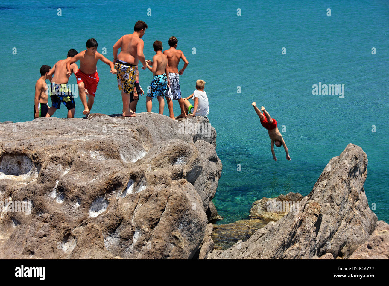 Boys diving from the rocks next to an Early Christian Basilica, at