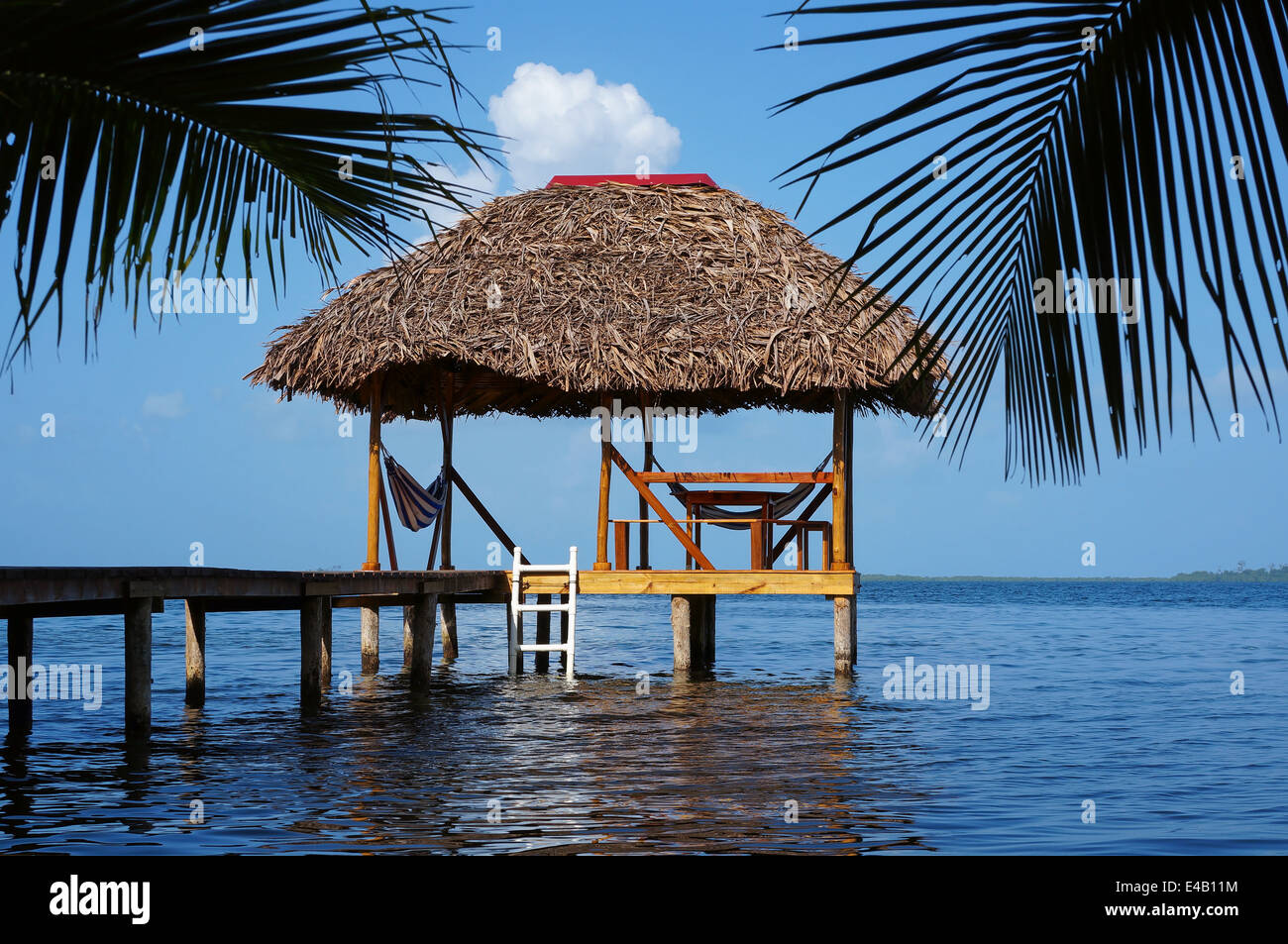 Palapa hut overwater with thatched roof made of dried palm leaves, Caribbean sea Stock Photo