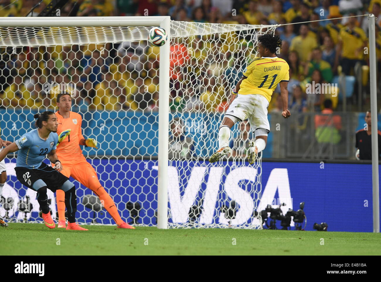 Rio De Janeiro, Brazil. 28th June, 2014. (R-L) Juan Cuadrado (COL), Fernando Muslera, Martin Caceres (URU) Football/Soccer : Juan Cuadrado of Colombia assists his team's second goal during the FIFA World Cup Brazil 2014 Round of 16 match between Colombia 2-0 Uruguay at Estadio do Maracana in Rio De Janeiro, Brazil . © SONG Seak-In/AFLO/Alamy Live News Stock Photo