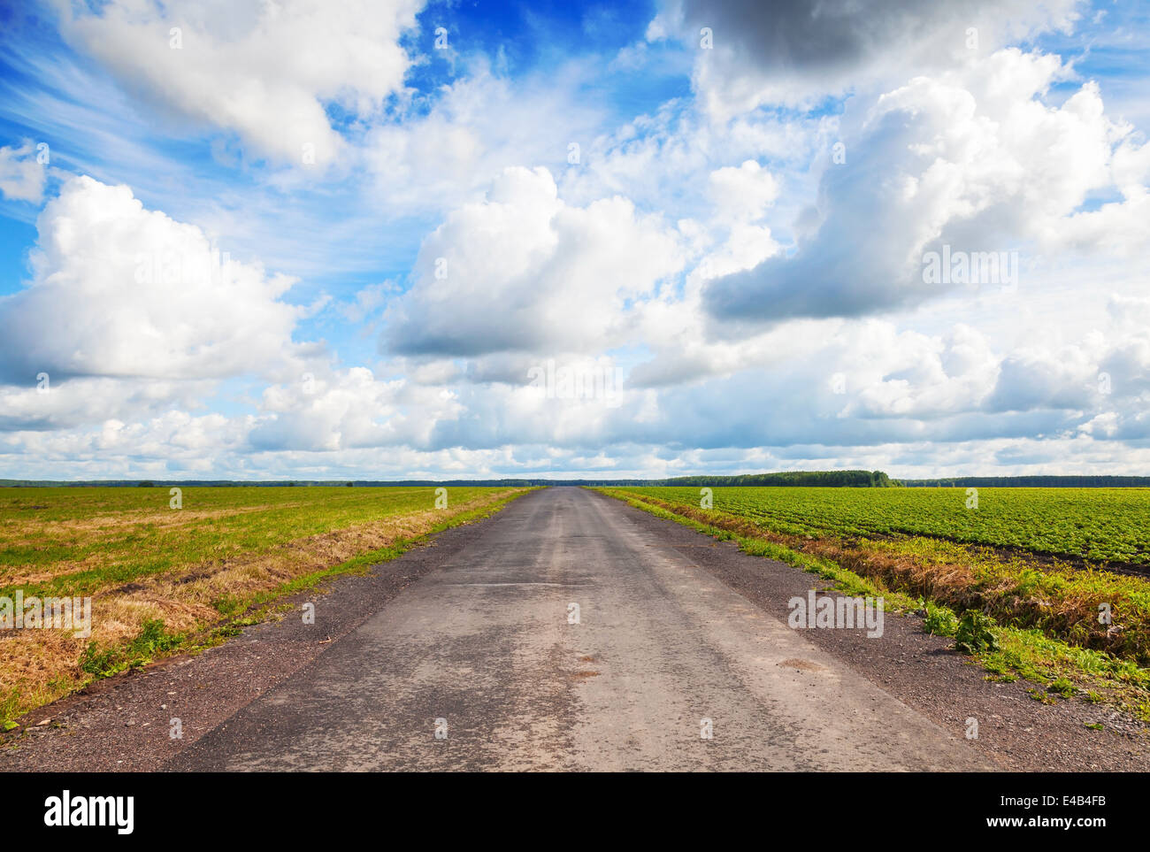 Empty country road perspective with dramatic cloudy sky Stock Photo