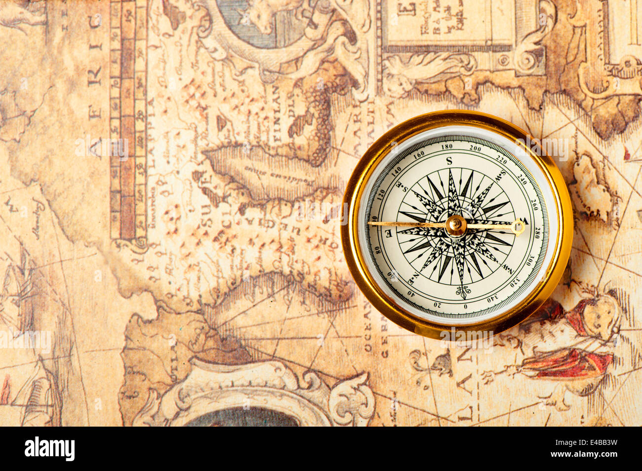 Old compass on ancient map Stock Photo