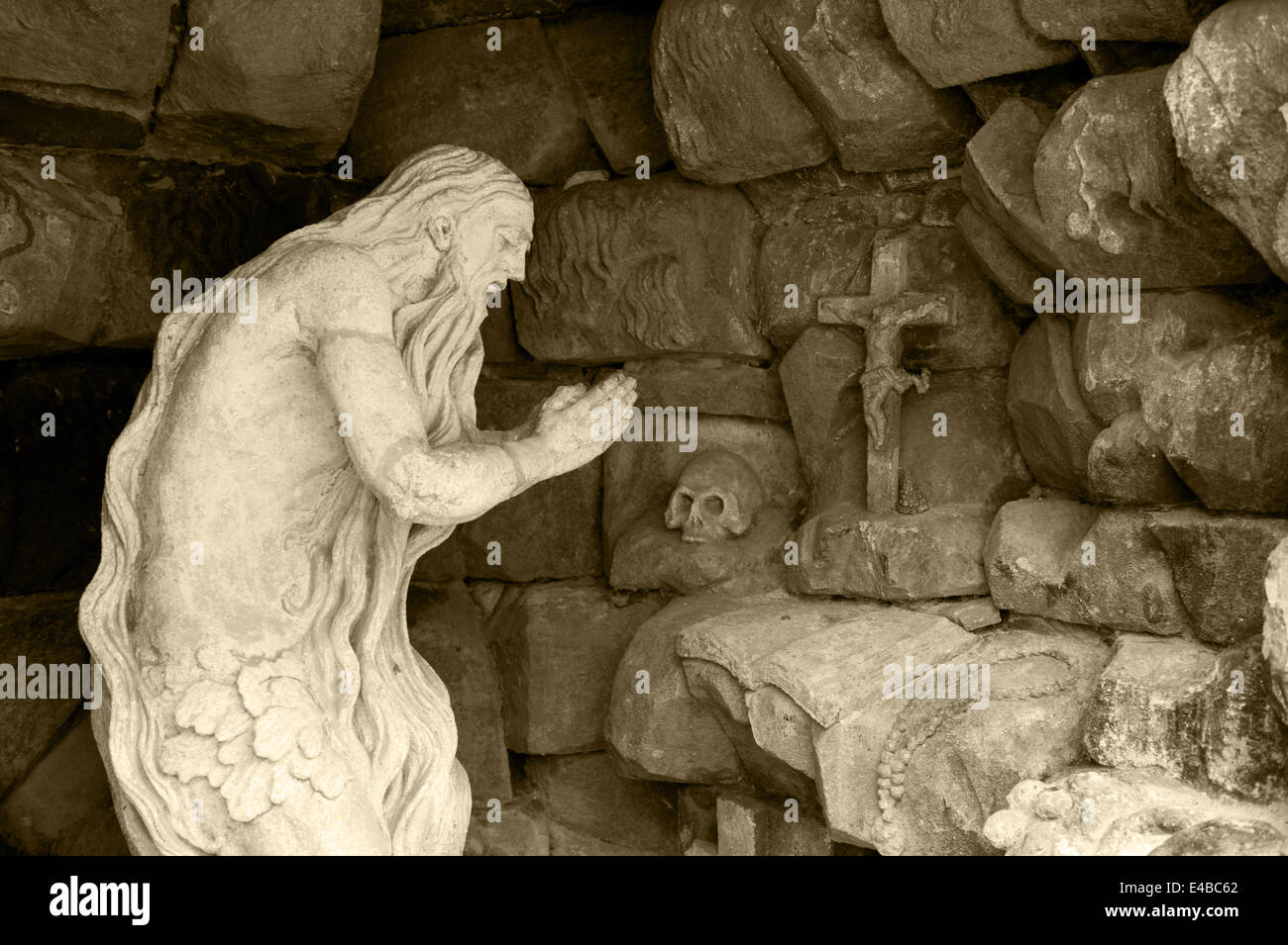 Monument praying elder in a cave Stock Photo