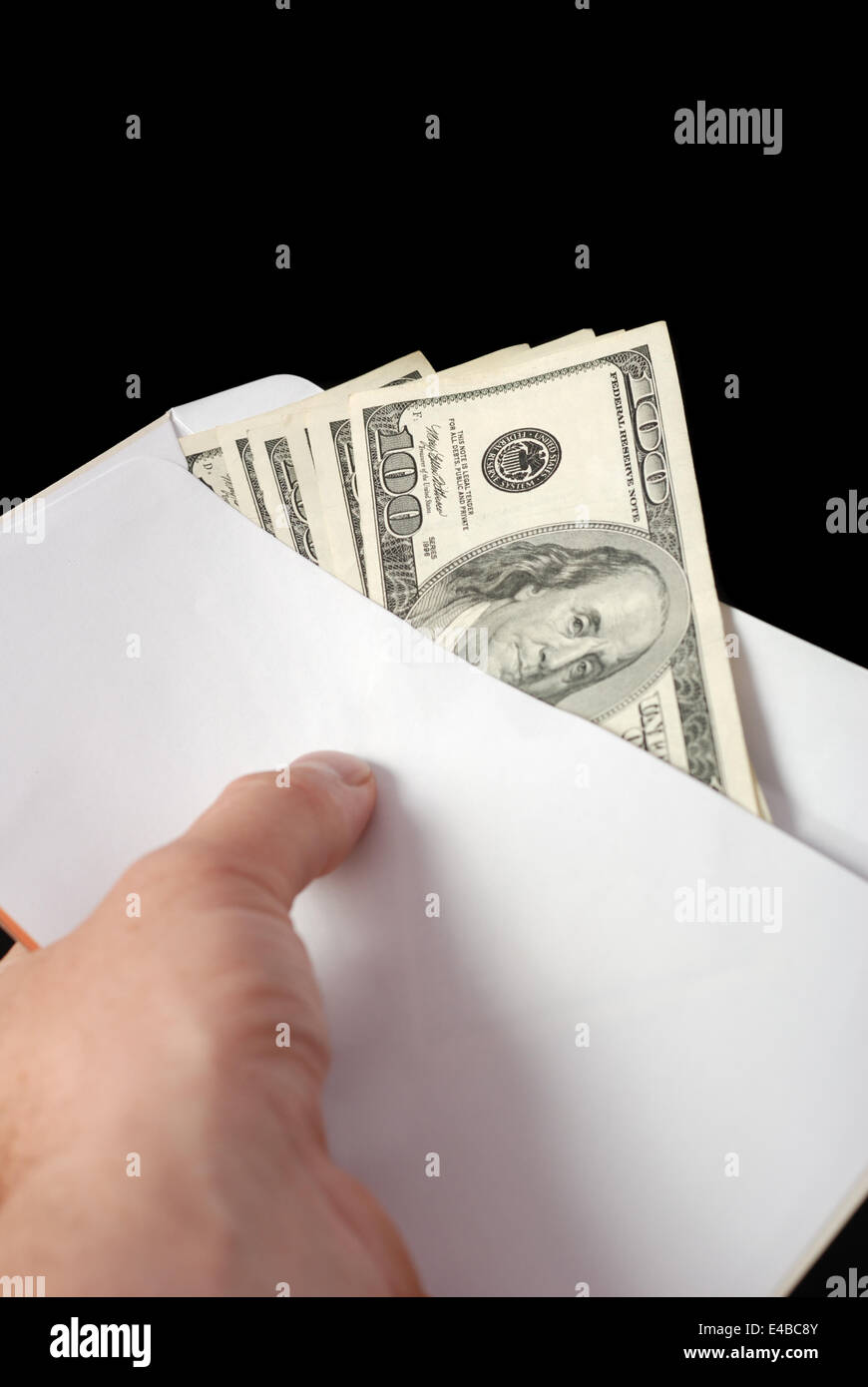 Bribe in an envelope and hand Stock Photo
