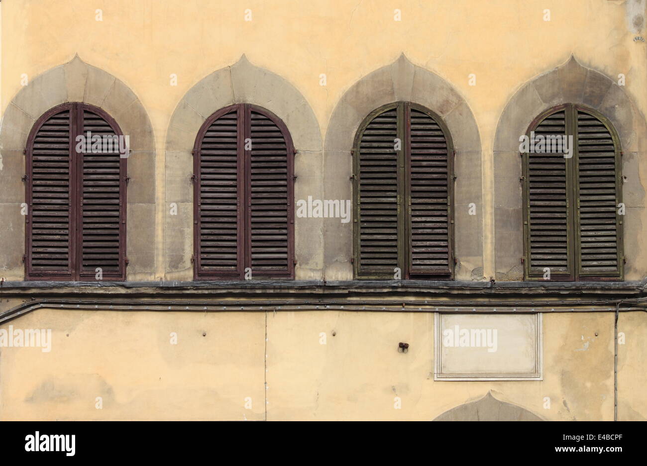 Arched windows with closed shutters Stock Photo