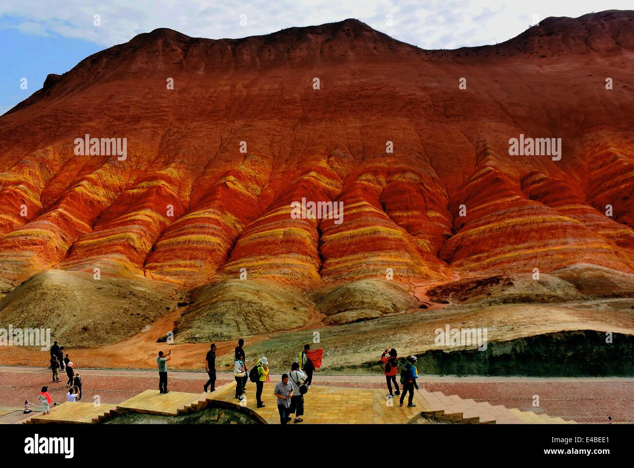 Xining. 7th July, 2014. Photo taken on July 7, 2014 shows the scenery at Zhangye Danxia Landform Geological Park in Zhangye City, northwest China's Gansu Province. Danxia, which means 'rosy cloud', is a special landform formed from reddish sandstone that has been eroded over time into a series of mountains surrounded by curvaceous cliffs and many unusual rock formations. © Wang Song/Xinhua/Alamy Live News Stock Photo