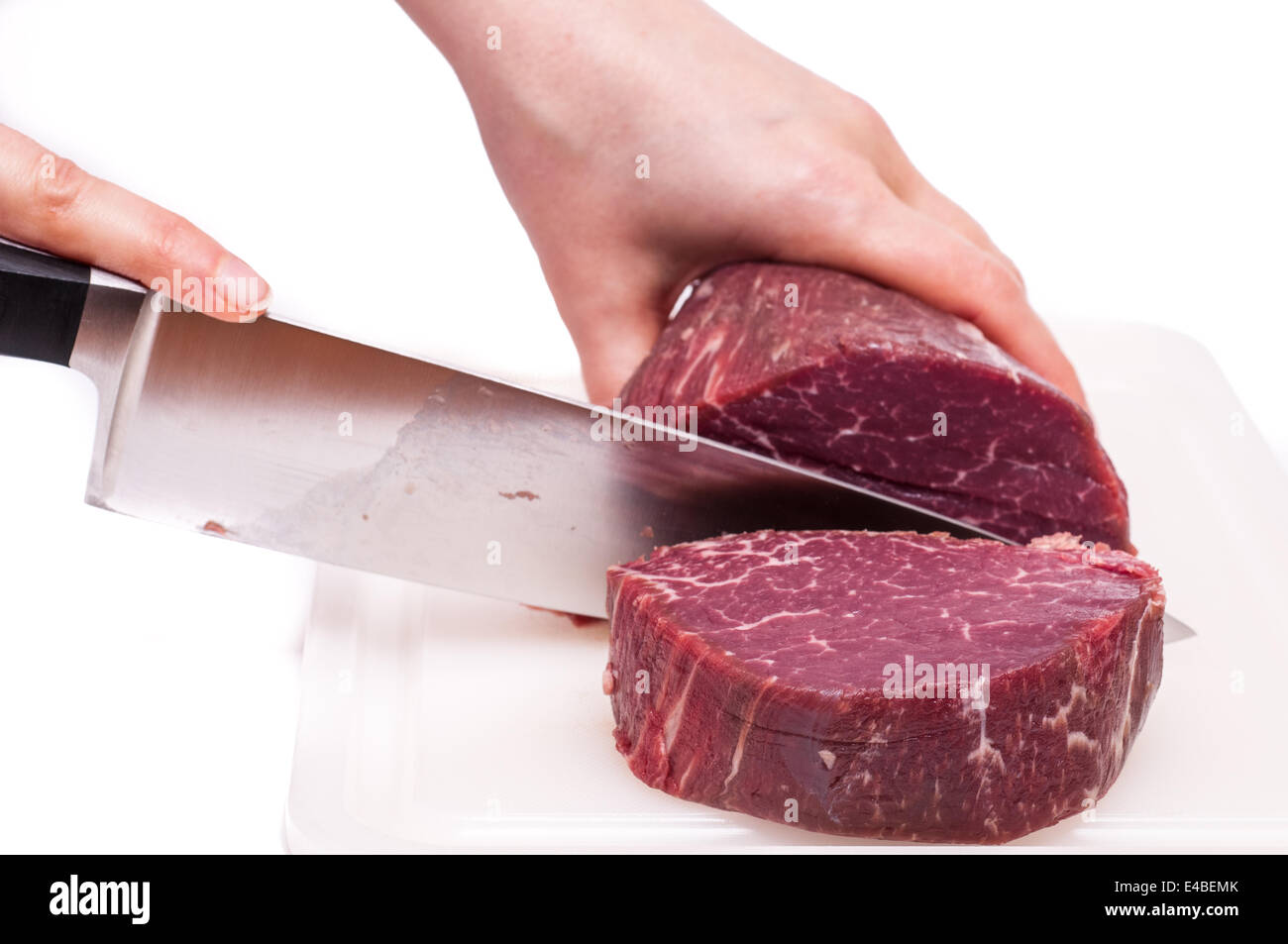 Cooking knife is slicing a fillet of beef Stock Photo