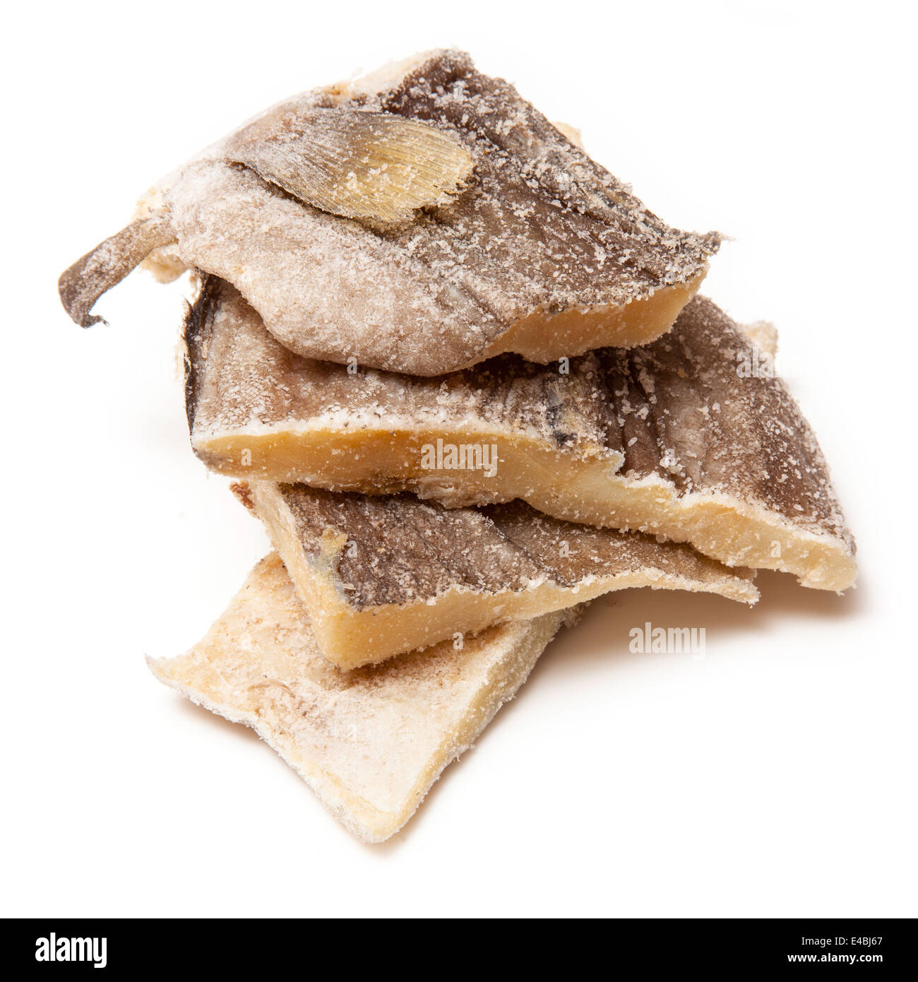 Pieces of salt cod fish isolated on a white studio background Stock