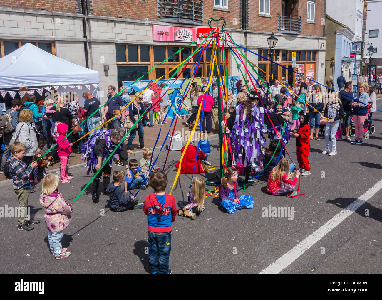 Children Maypole Dancing at Poole Quay, Dorset, England, UK Stock Photo