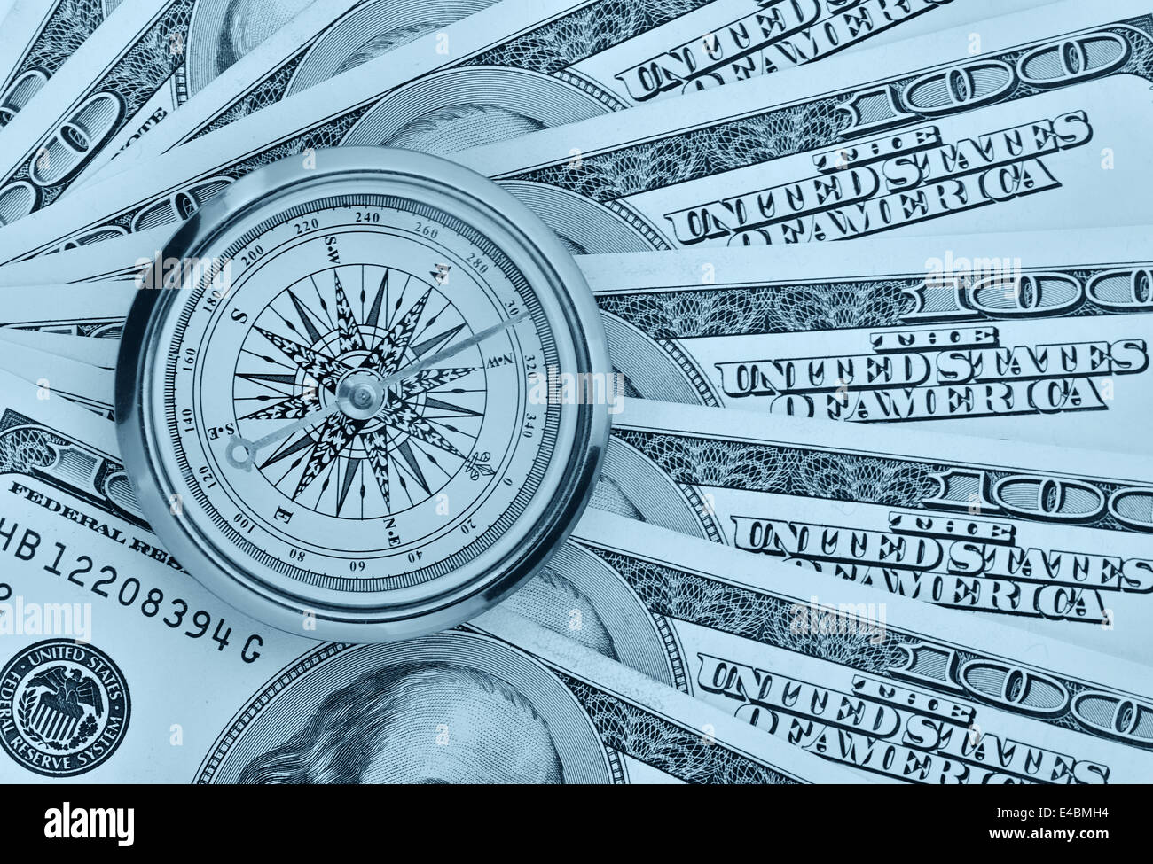 Dollars and compass Stock Photo - Alamy