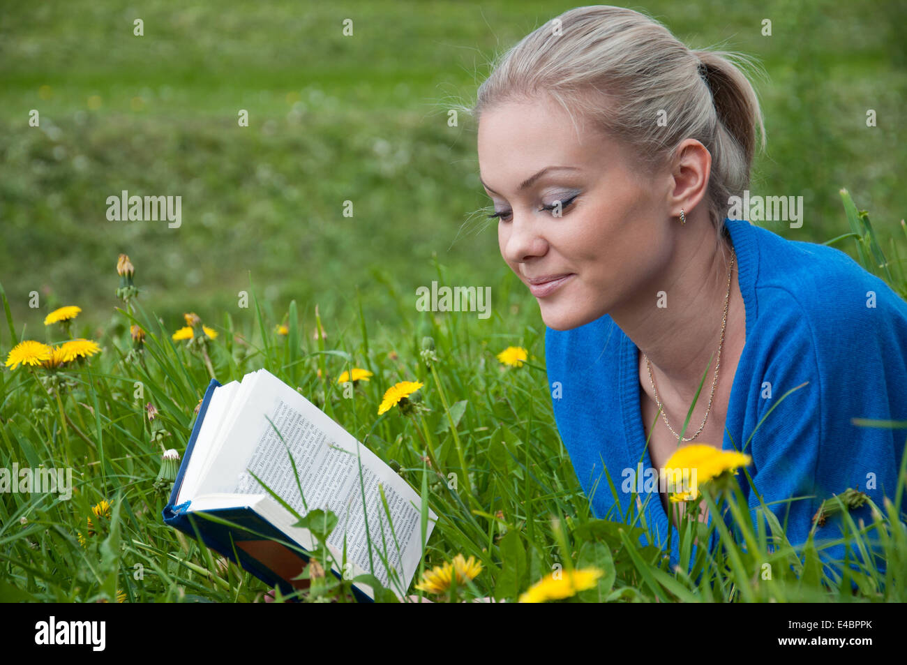 A girl student with a book in the park Stock Photo - Alamy