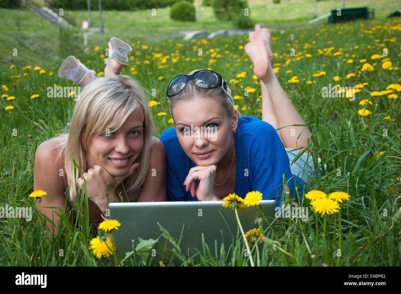 Two girls student with a laptop in the park Stock Photo