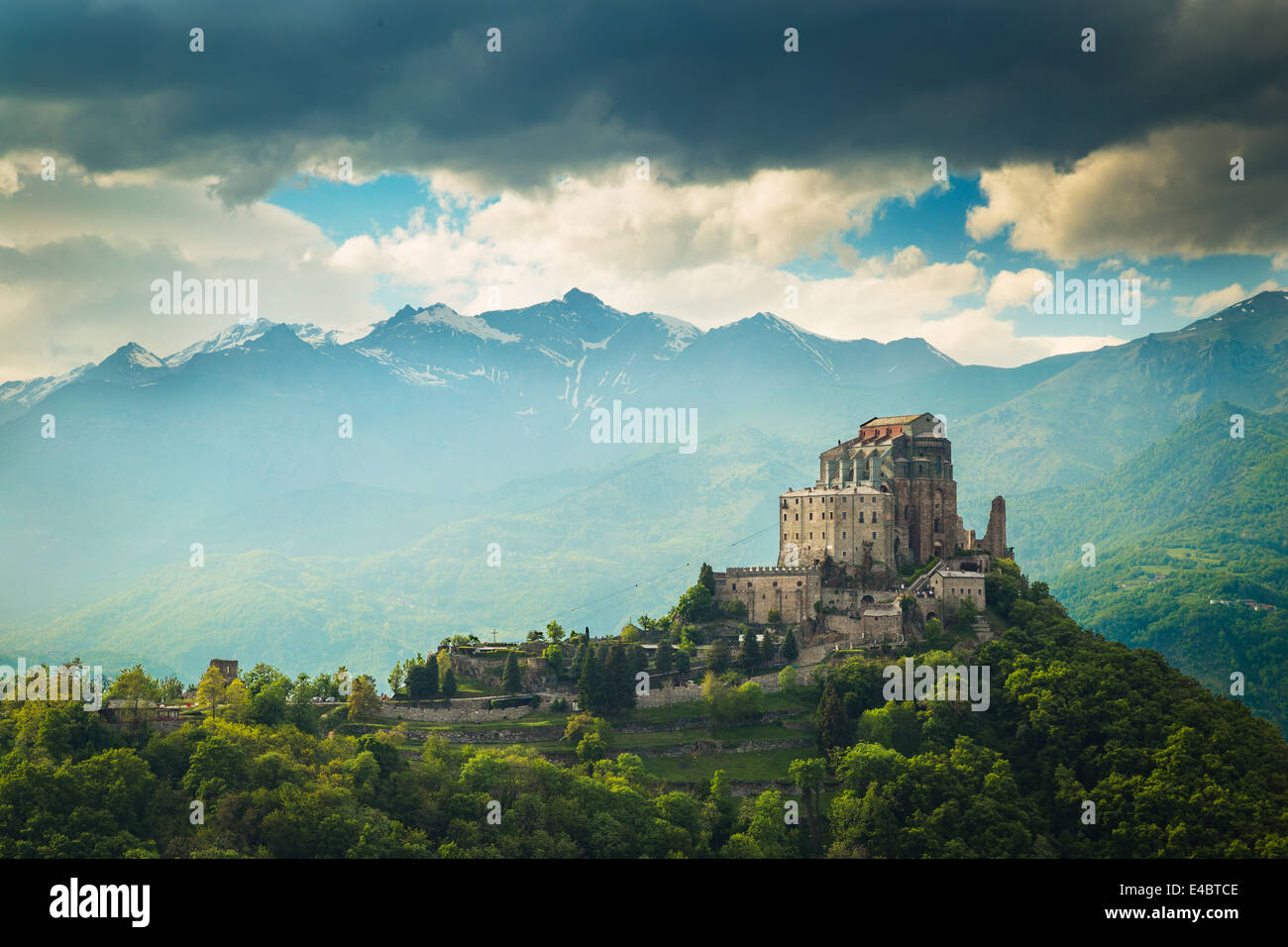 Tthe monastery church of Sacra di San Michele in the Susa Valley, Italy. The Alps rise up in the background with Rocciamelone the most prominent peak. Stock Photo