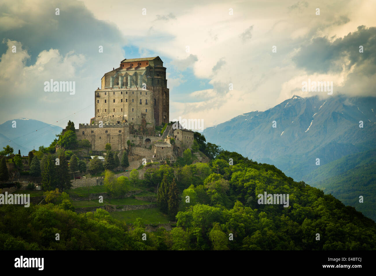 Monastery church of Sacra di San Michele in the Susa Valley, Italy. The Alps rise up in the background with Rocciamelone the mountain to the right. Stock Photo