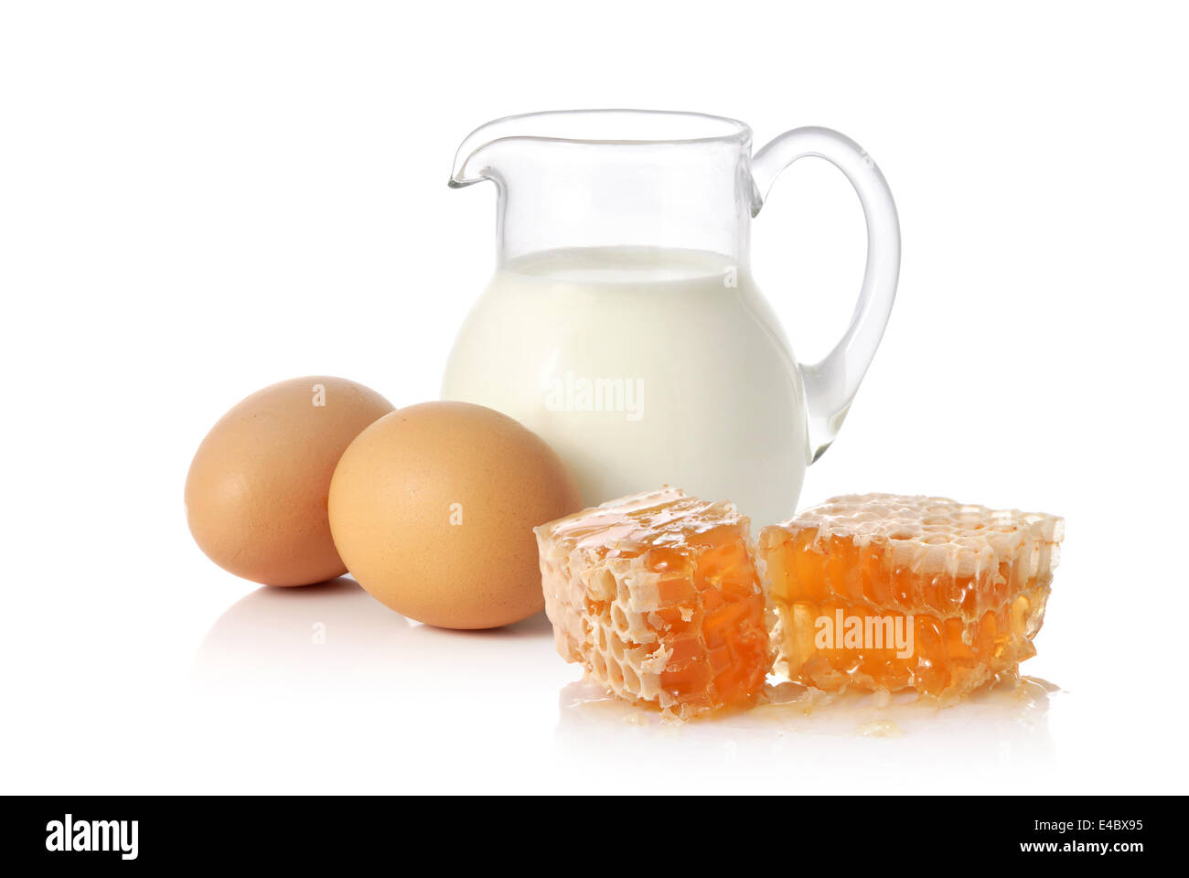 Fresh milk, two eggs and honey Stock Photo Alamy