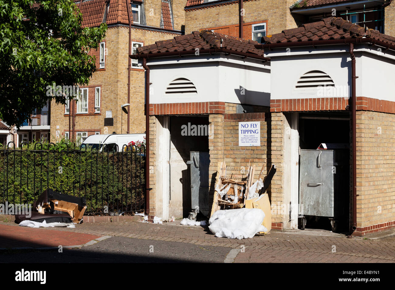 Illegally Dumped Rubbish Left Below A No Fly Tipping Sign, Rotherhithe, London, England Stock Photo