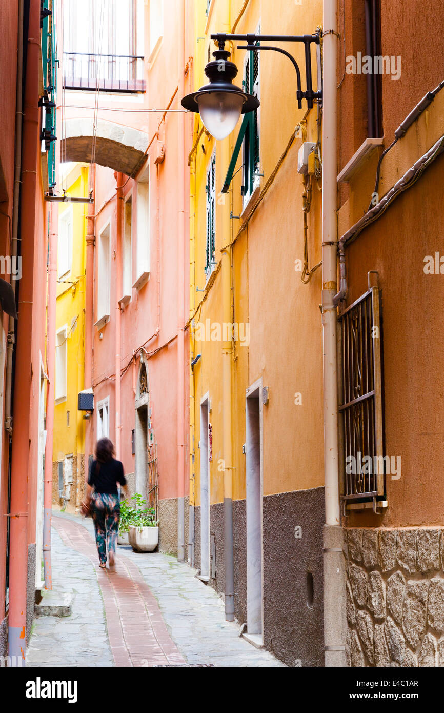 Woman walks through the backstreets of Corniglia Stock Photo