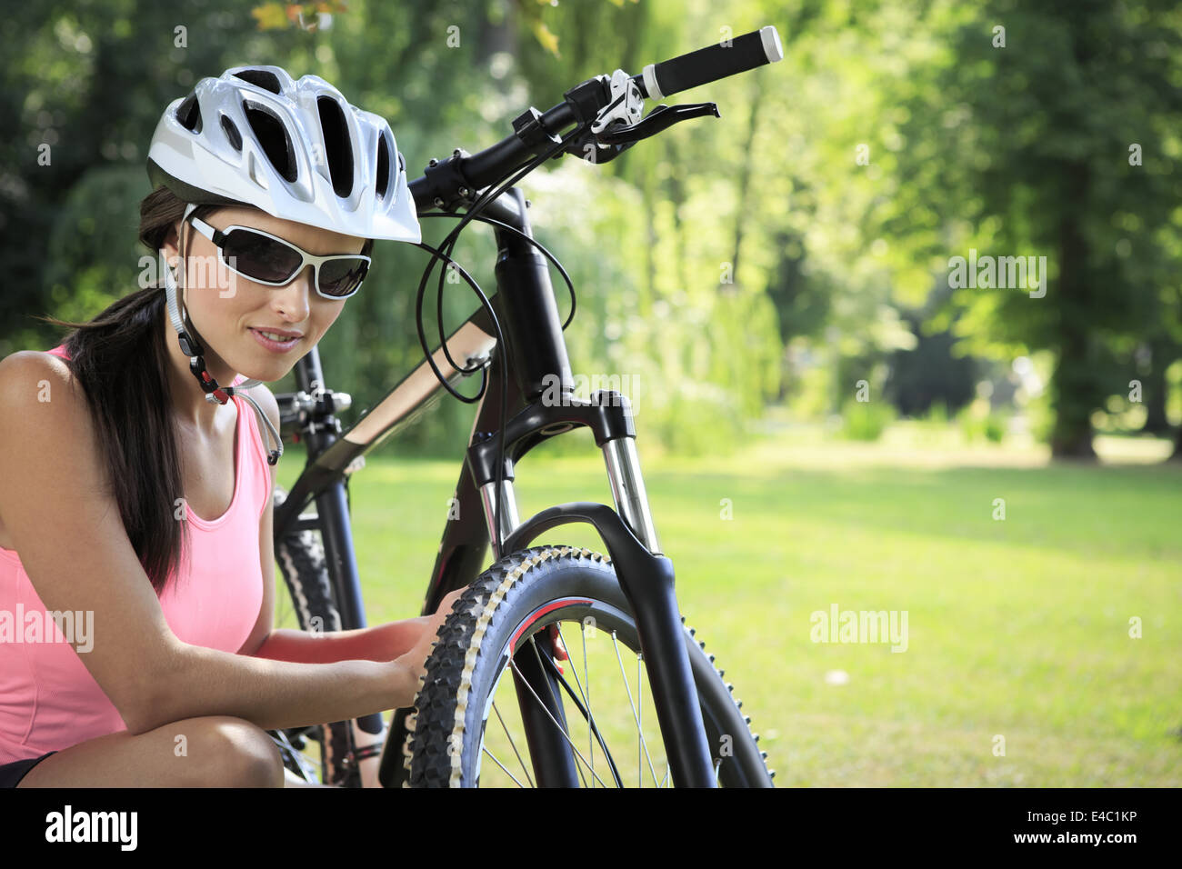 cycling woman taking a break in the park Stock Photo