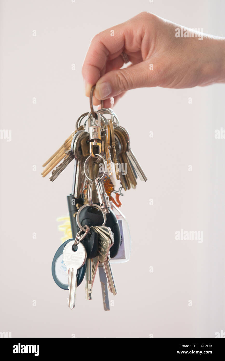 Hand holding large bunch of keys Stock Photo Alamy