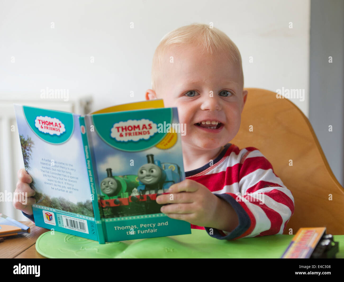 a young boy child reading a book Stock Photo