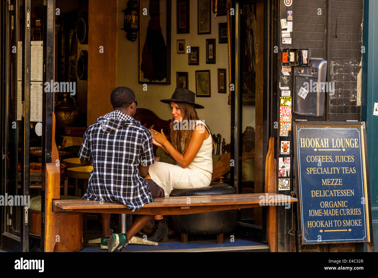 Two People Sit Chatting In A Cafe, Brick Lane, London, England Stock