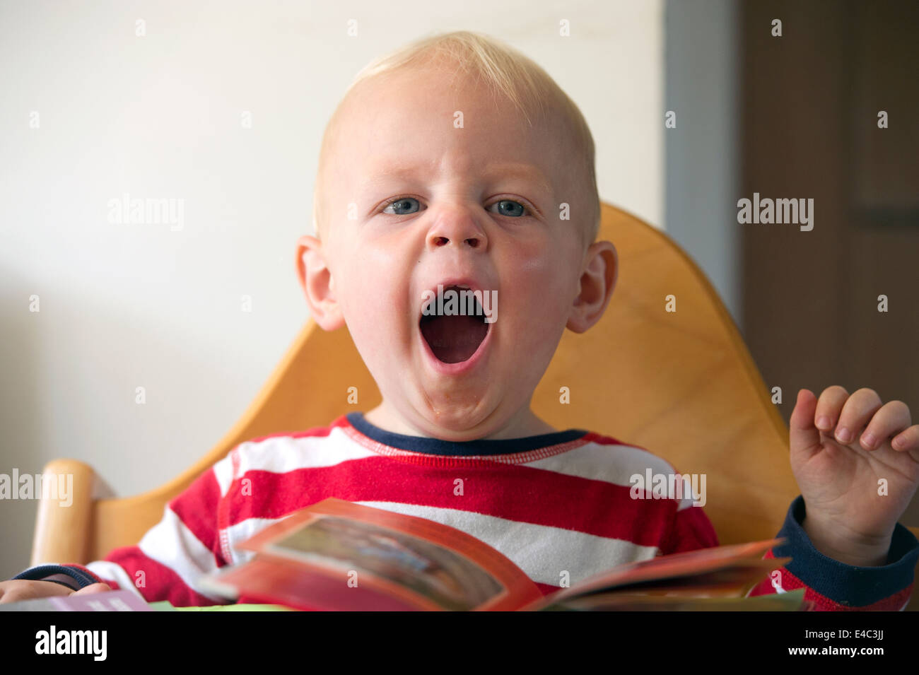 a young child yawning Stock Photo