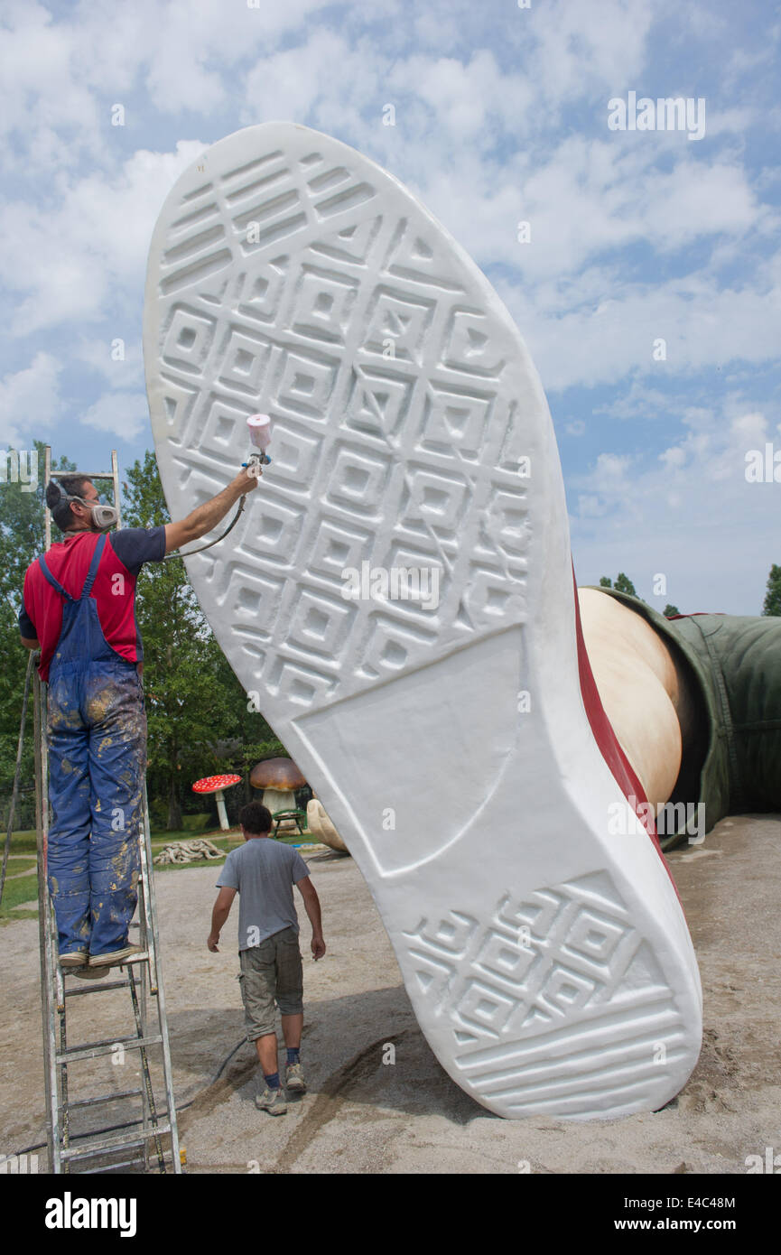 Usedom, Germany. 08th July, 2014. Workers work on a shoe of a figure of  Gulliver at amusement park 'Gulliver's World' in Pudalga on Usedom,  Germany, 08 July 2014. The sculpture of Gulliver