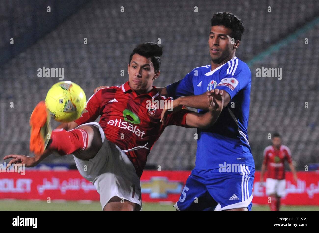 Cairo, Egypt. 7th July, 2014. Smouha's Said Farid (R) fights for the ball with Al-Ahly's Amro Gamal (L) during the Egyptian Premier League soccer match at the Cairo Stadium in Cairo, Egypt, 07 July 2014 © Nameer Galal/NurPhoto/ZUMA Wire/Alamy Live News Stock Photo