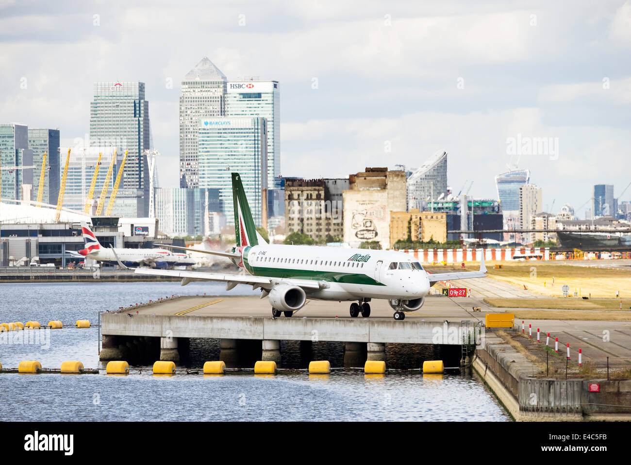 An Alitalia CityLiner passenger jet taxis prior to takeoff at London City Airport Stock Photo