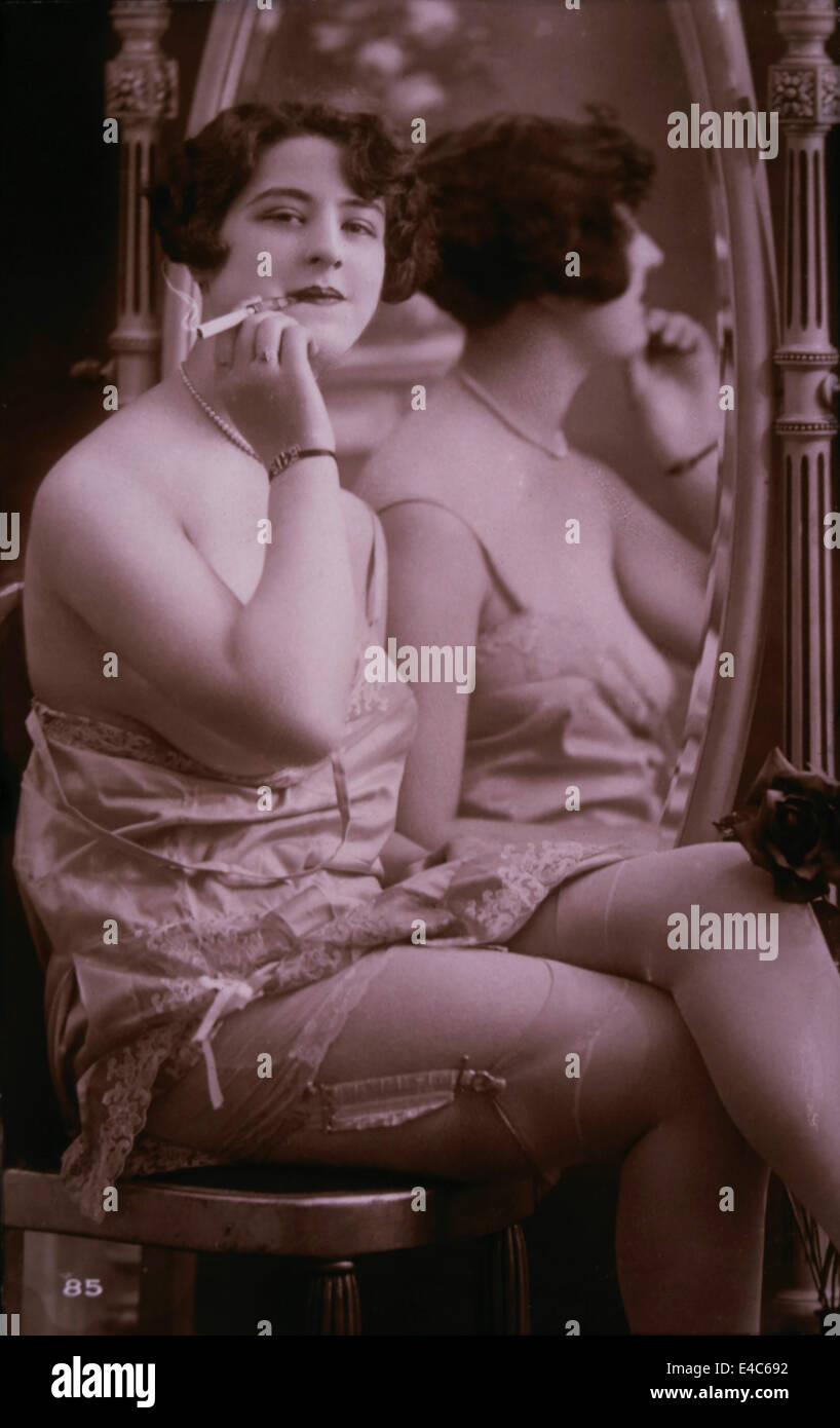 Lingerie Model Seated Beside Mirror Holding a Cigarette, circa 1920 Stock  Photo - Alamy