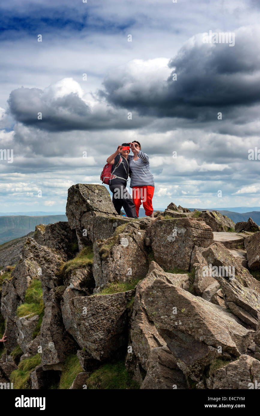 Two young ladies on Striding Edge taking self portraits of themselves ... "selfies" Stock Photo