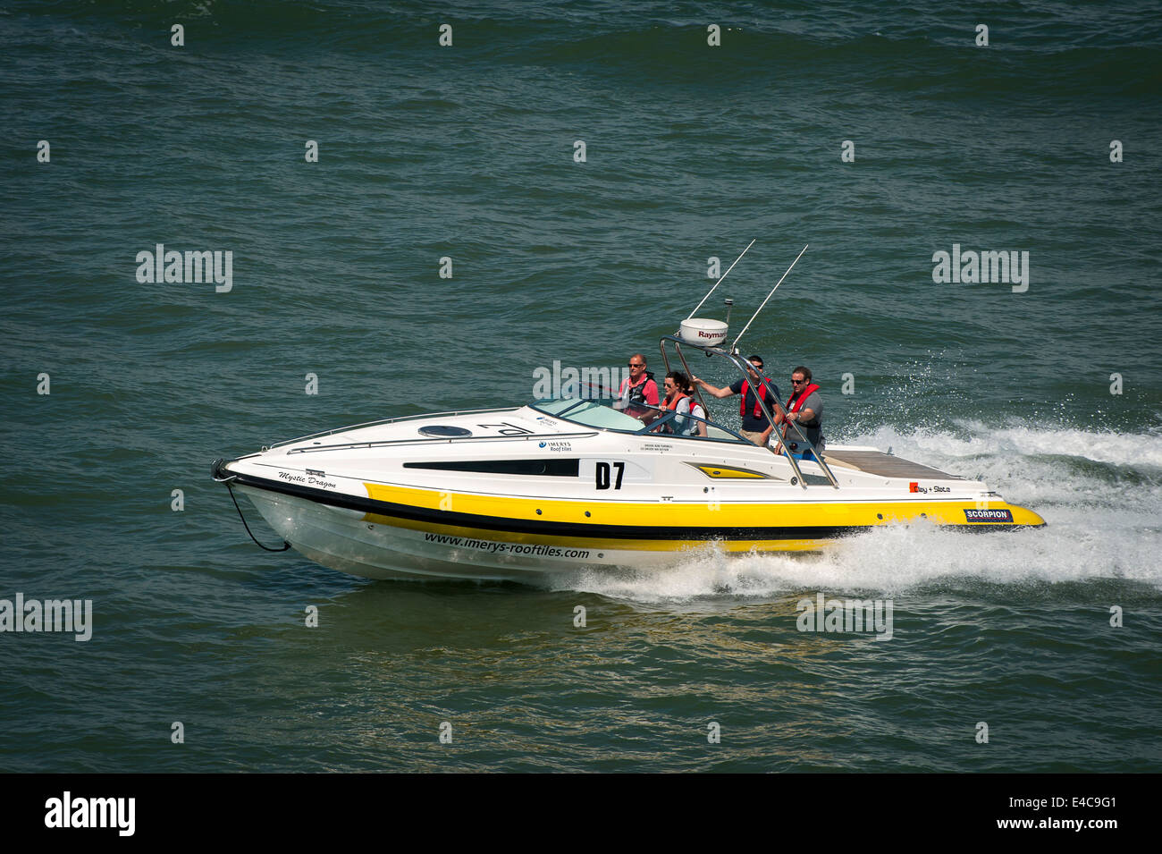 Speed boat speeding through the water just off the coast of the Isle of