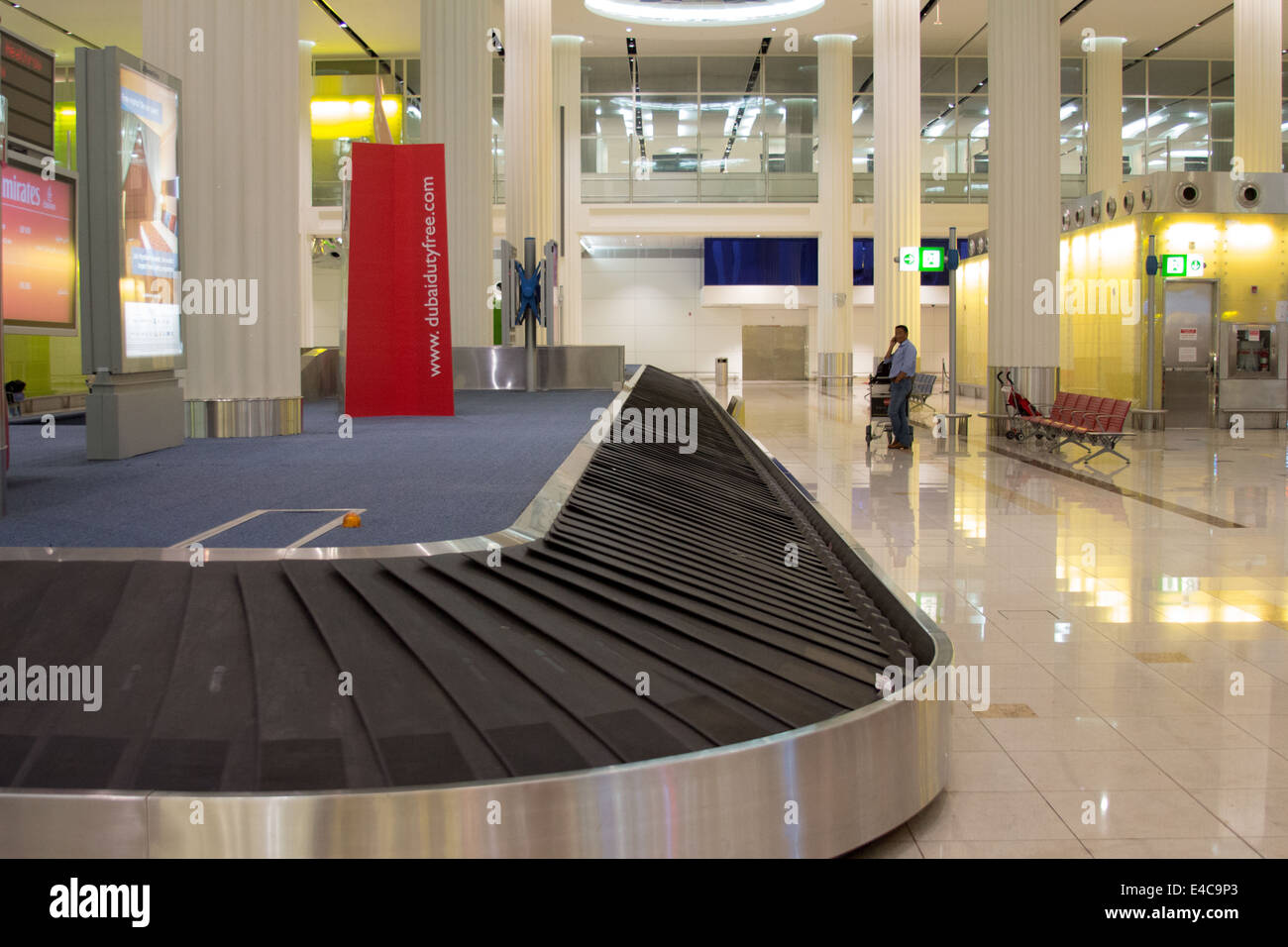 Man waiting at Dubai international Airport, Terminal 3, baggage Stock