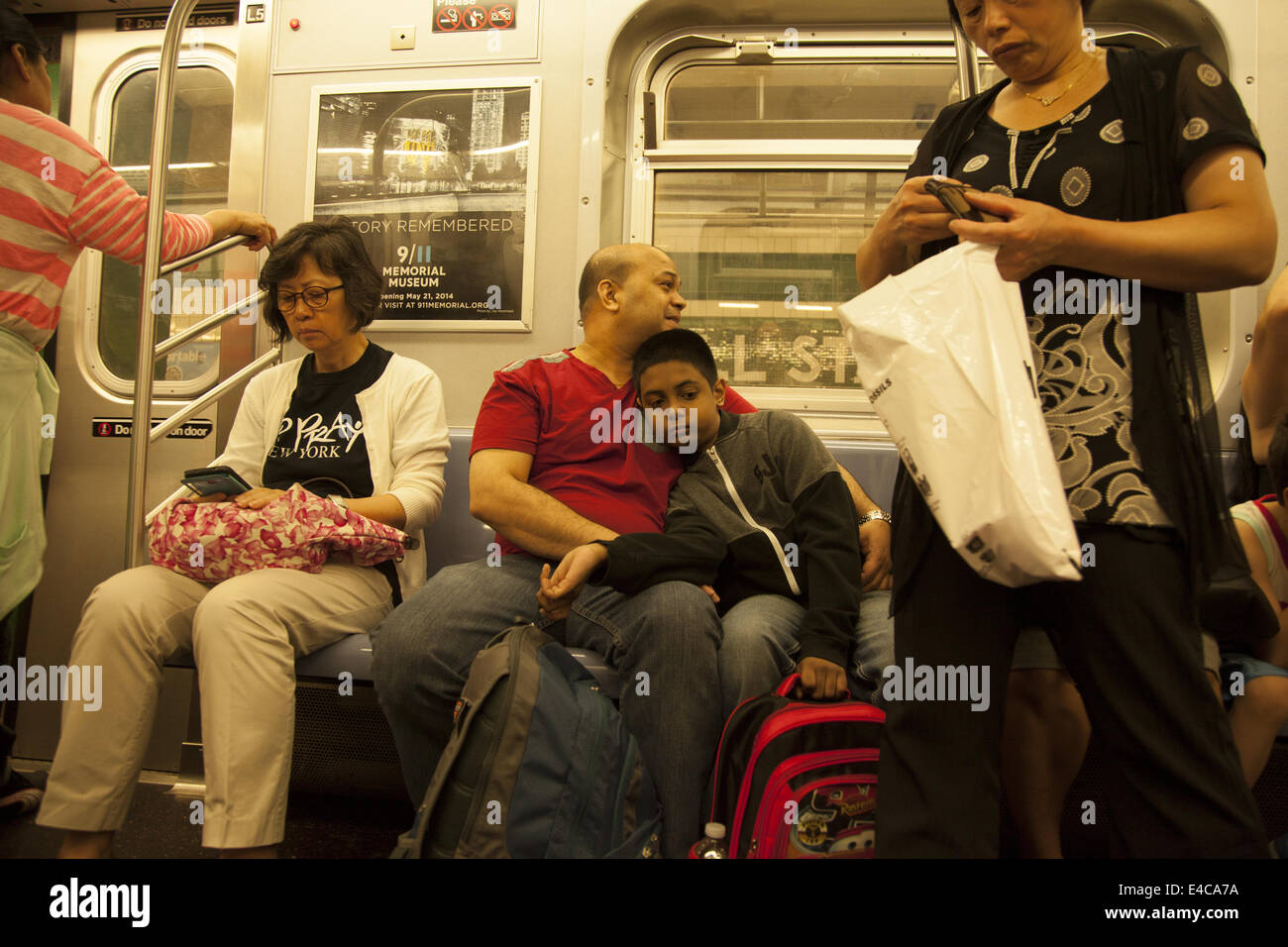 People ride a New York City Subway train in Brooklyn, NY Stock Photo