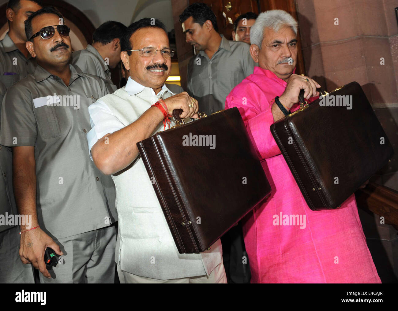 New Delhi, India. 8th July, 2014. Indian Railway Minister Sadananda Gowda (C) and his deputy Manoj Sinha (1st R) are seen at the gate of Parliament House to present the railway budget for the 2014-15 fiscal year in New Delhi, India, July 8, 2014. Credit:  Xinhua/Alamy Live News Stock Photo