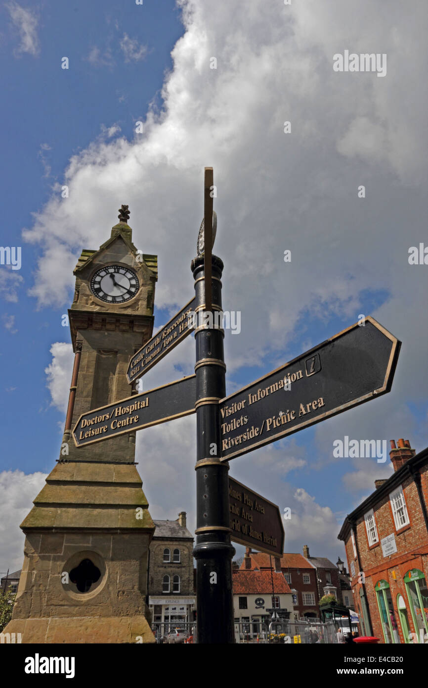 Tourism signpost and clocktower in Market Square, Thirsk, North Yorkshire Stock Photo