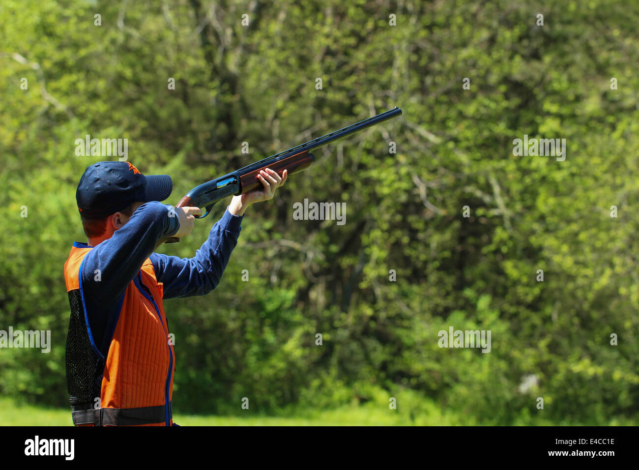 Young man skeet shooting or trap shooting at clay targets Stock Photo