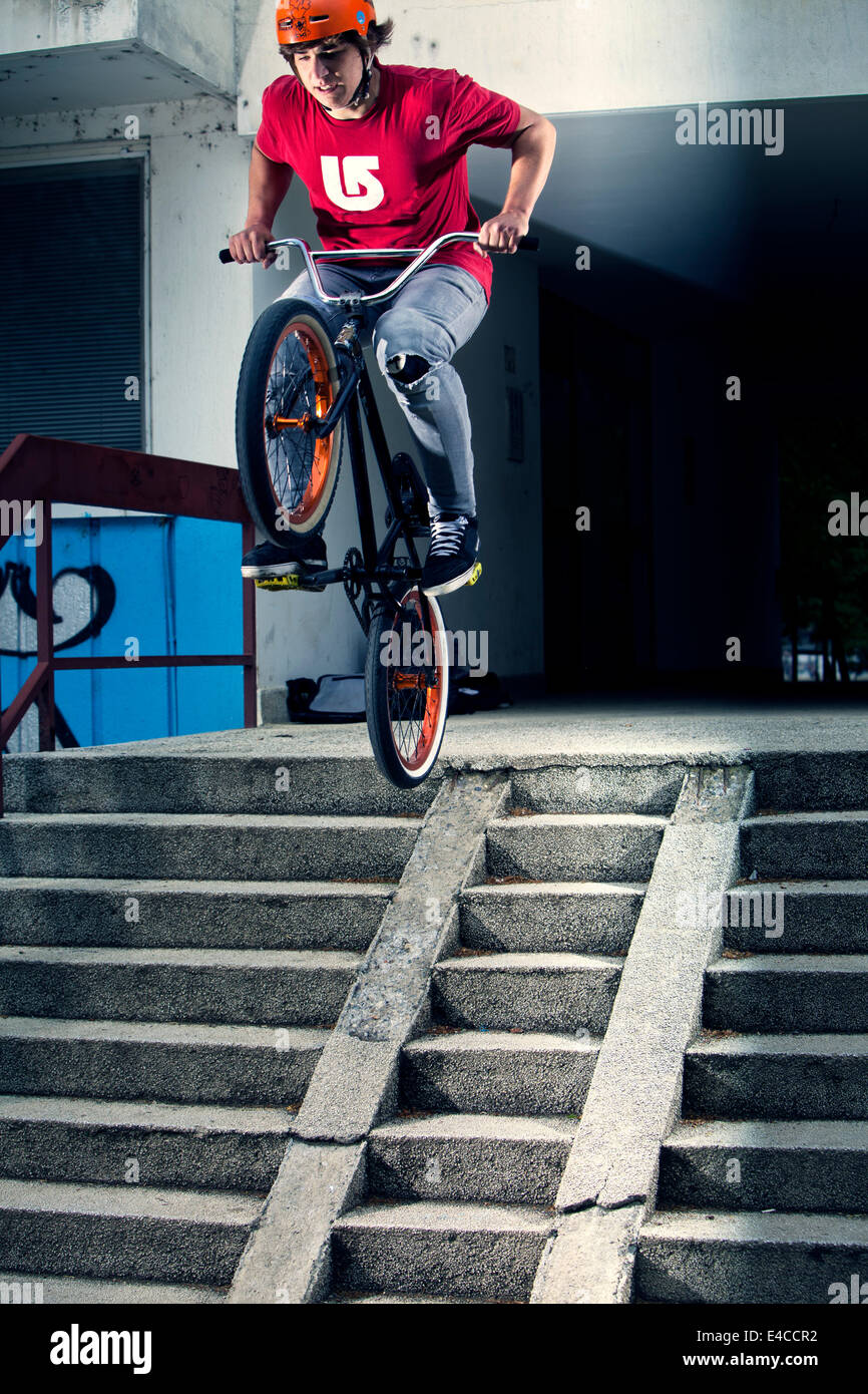 BMX biker performing a stunt on a staircase Stock Photo
